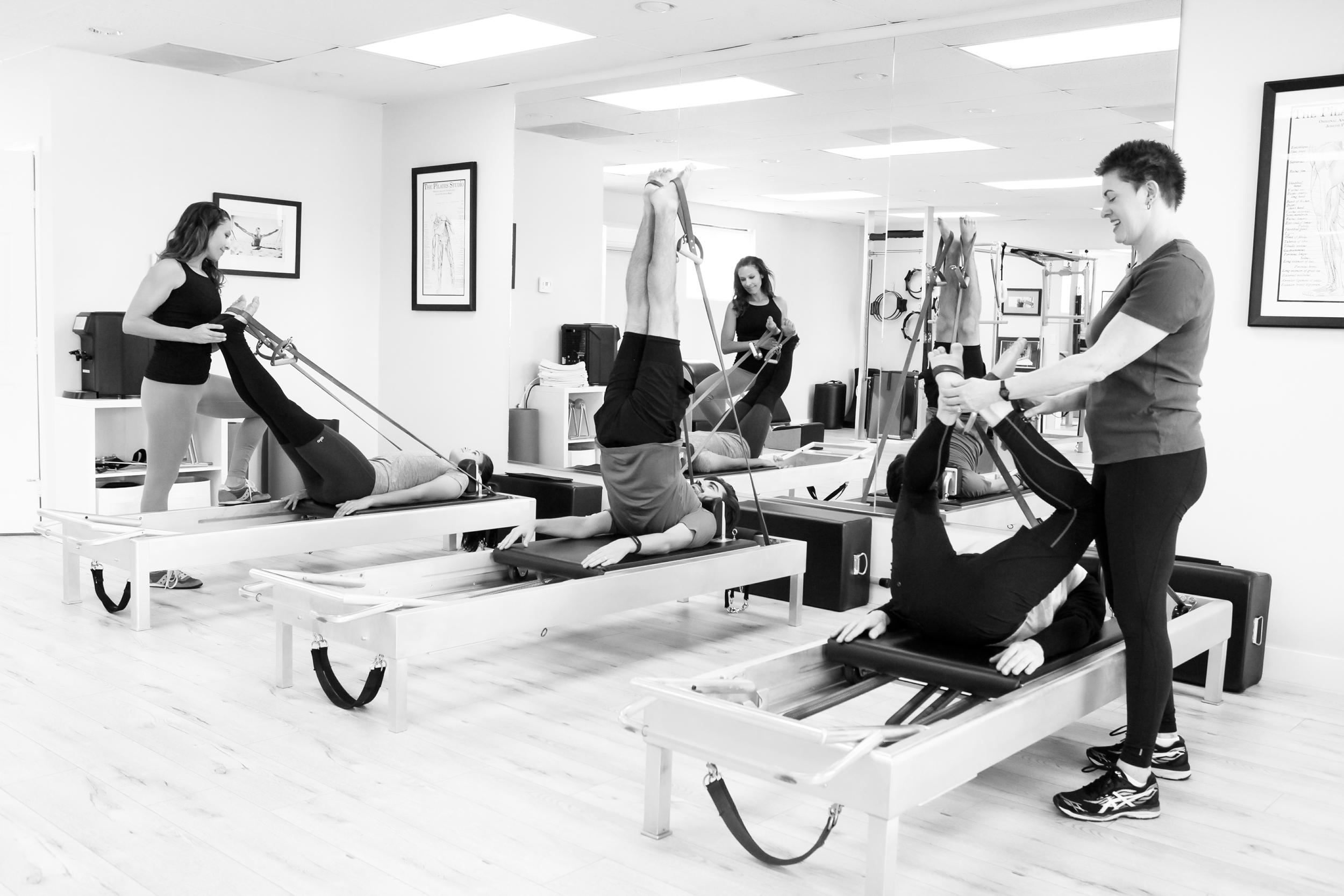 Teachers working with Pilates students